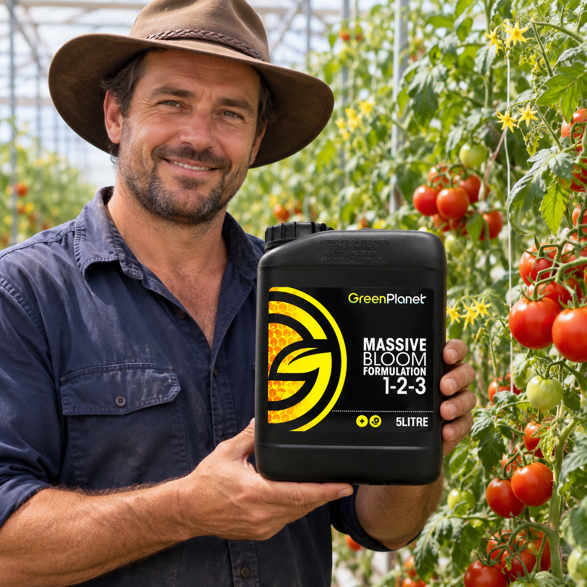 Adult Australian tomato greenhouse grower presenting a closed black 5L jug of GREEN PLANET MASSIVE BLOOM.