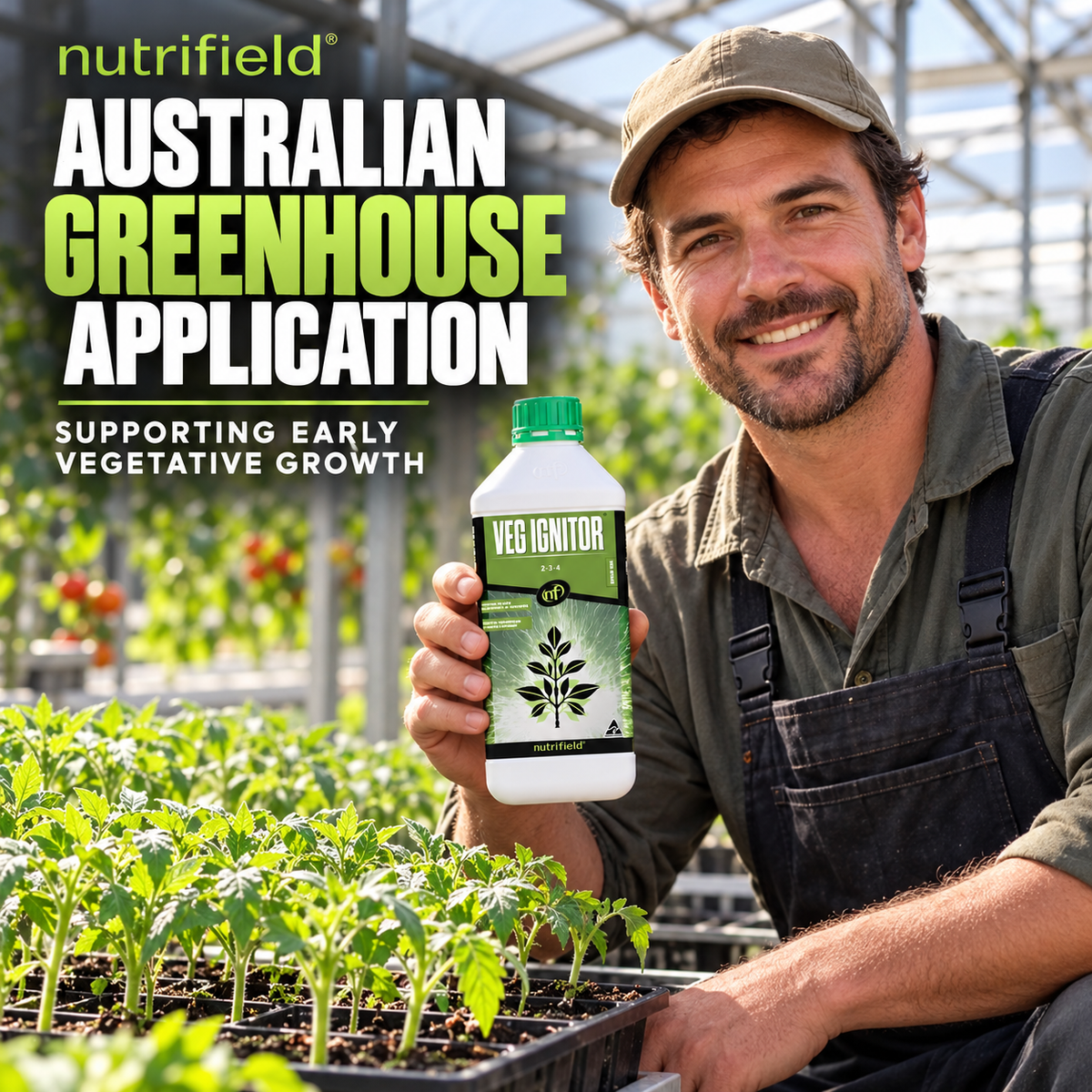 Australian greenhouse grower holding a Nutrifield Veg Ignitor bottle beside young tomato seedlings.